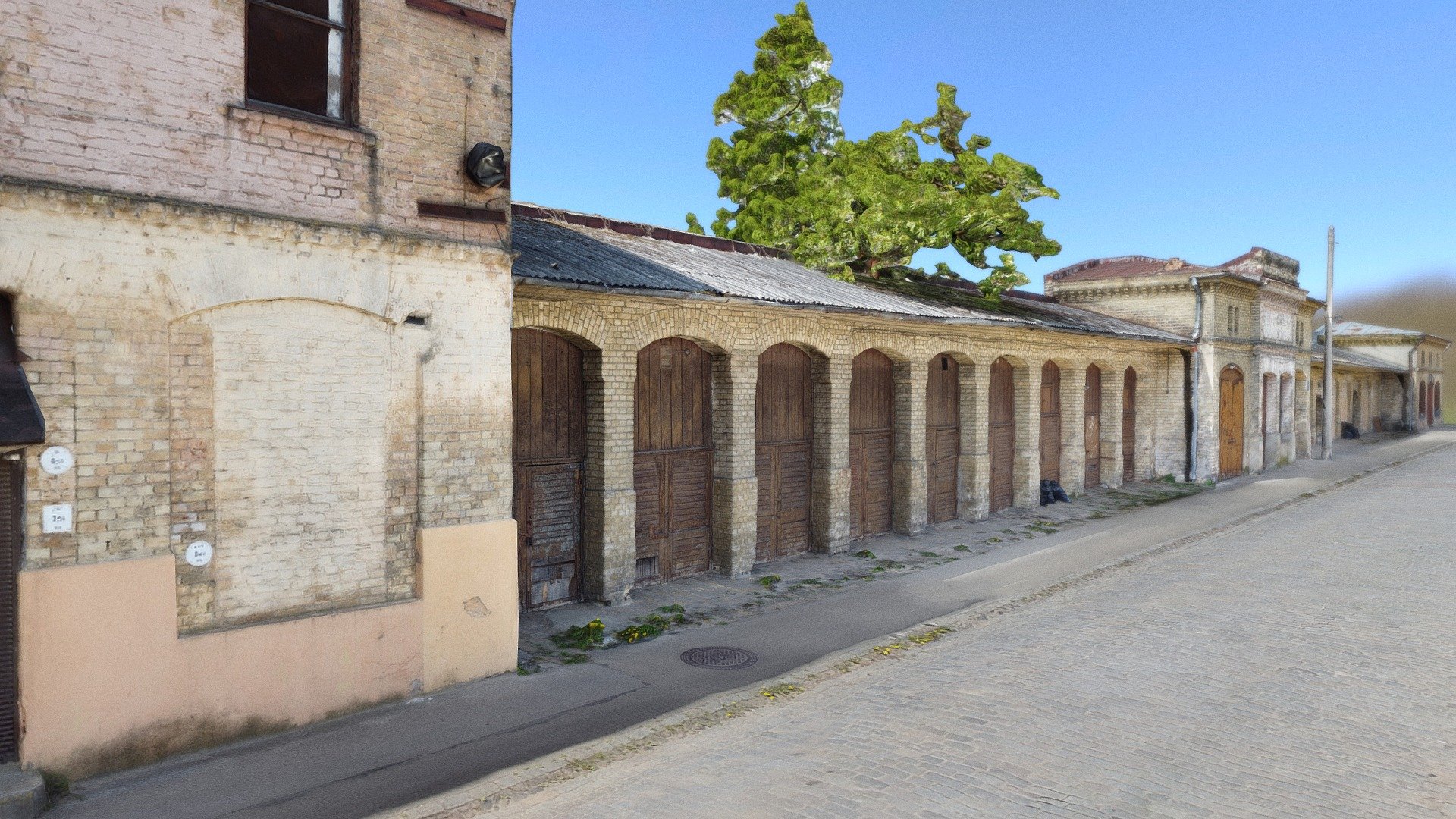 Building with many storage doors used for &lsquo;storing horses.
Also known as stables. 
Brick walls and a tree behind the roof.