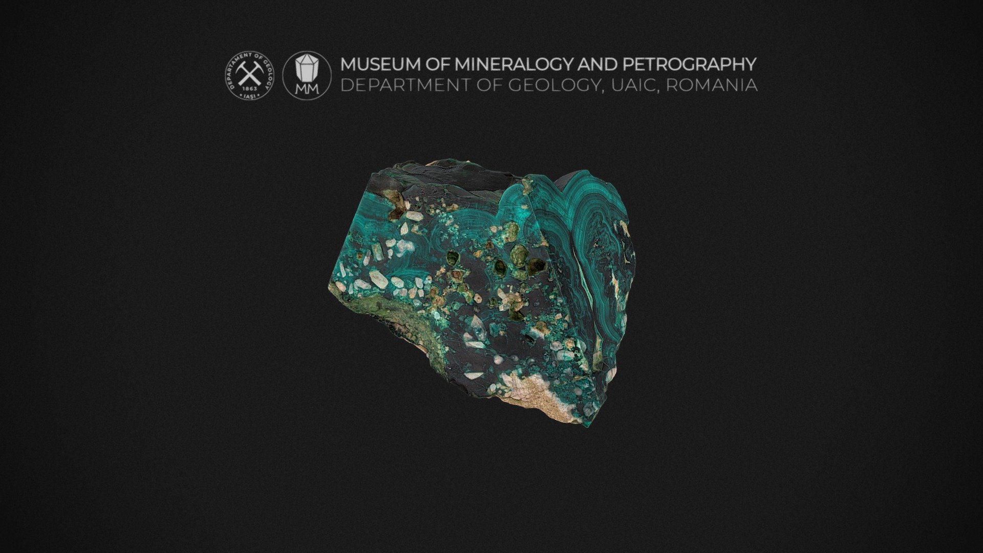 Locality: Zhezqazghan, Kazakhstan

No.: 5642

Size: 12 cm x 10 cm x 6 cm

Formula: Cu5(PO4)2(OH)4

Description: Pseudomalachite is an emerald green to dark green and blackish-green, monoclinic mineral consisting of a hydrated basic copper phosphate. It is also known as tagilite. Pseudomalachite is found in oxidized zones of copper deposits. This sample comes with radial fibrous and concentric inner structure, and reniform/botryoidal surface.
The name Pseudomalachite comes from the Greek for “false” and “malachite”, because of its similarity in appearance to the carbonate mineral malachite.

Website: http://geology.uaic.ro/muzee/mineralogie/

Concept &amp; 3D-modelling by dr. Andrei Ionut APOPEI